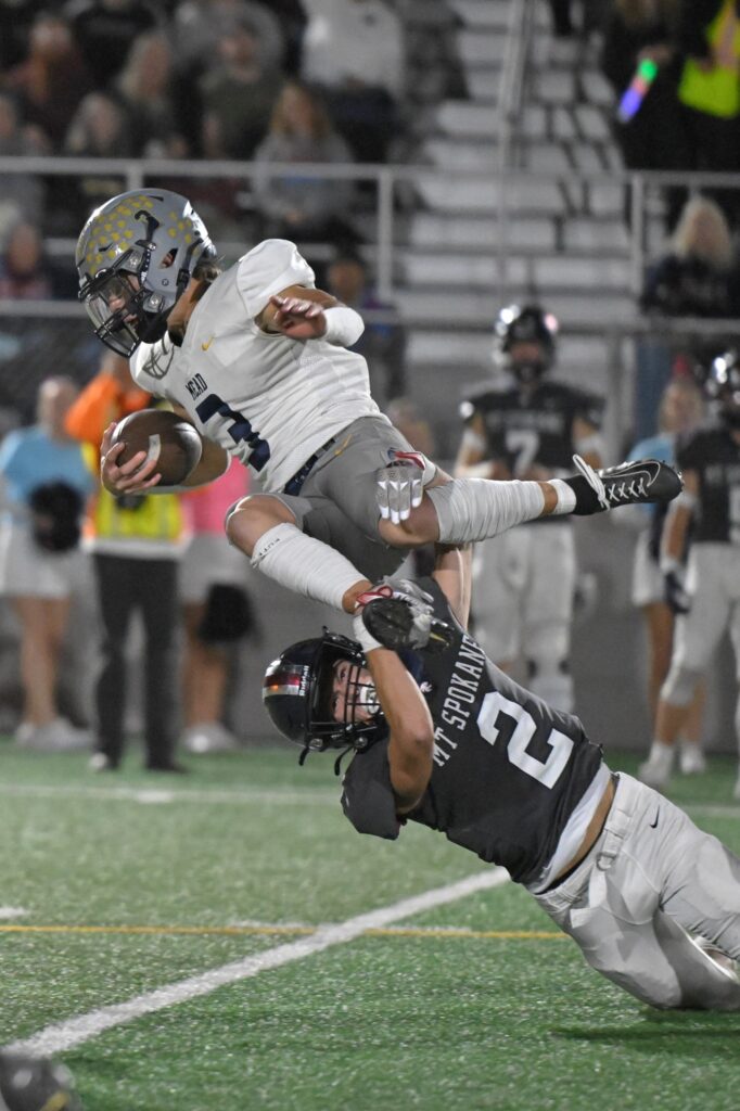 Football player jumping over. defensive lineman